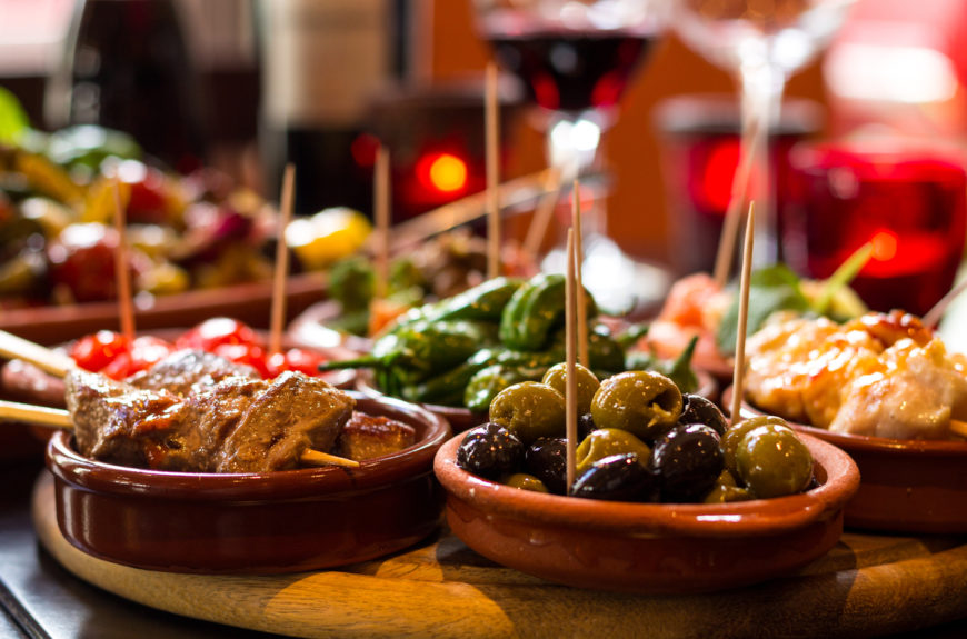 A plate of olives and tapas.